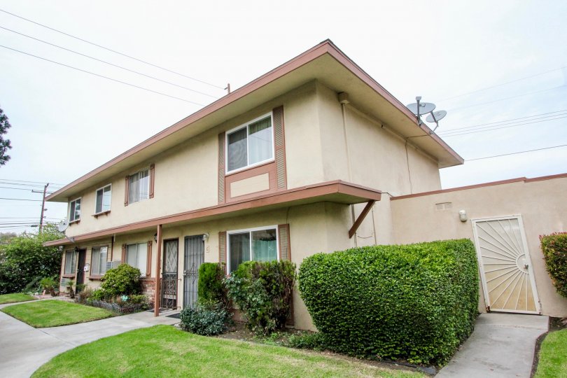 Near the door of the Home in Valley view Villas has cutted bushes with meadows and dish antenna is connected at terrace