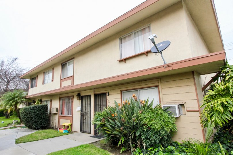 a rainy day in the valley view villas with house that has dish antenna and windows on ac and garden in the front