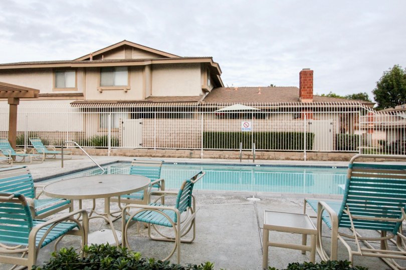 Nice view of swimming pool with chairs near villas in Village park of Buena Park