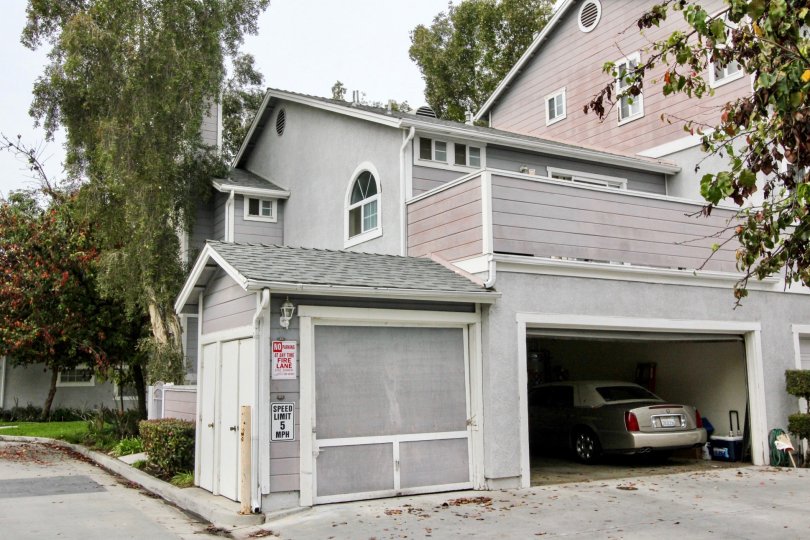 THIS IMAGE VIEWS THE HOUSE WITH CAR SHED NEARBY ROAD WITH PLANTS, TREES ARE THERE IN BUENA PARK