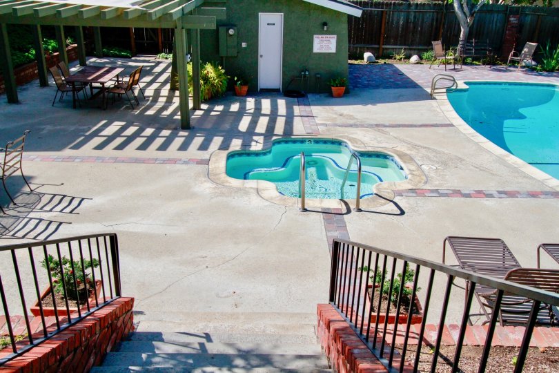 Back Bay Village Sunrise pool and hot tub with a staircase.