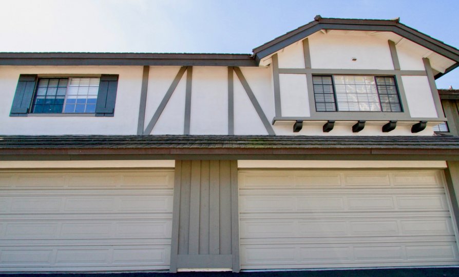 A double door garage with ustairs windows in the Brittanywoods community of Costa Mesa California