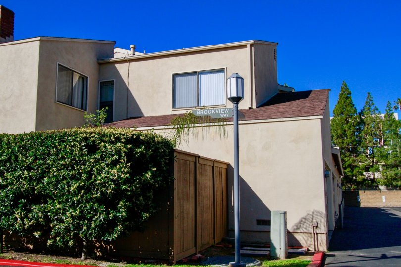 Beige house, with high privacy fence, hedges, street lamp, Brookview, Costa Mesa, California
