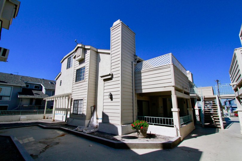 Coral Point apartments with patios, staircase, and balcony on a sunny day.