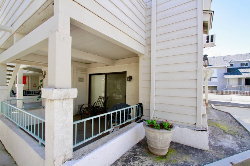 THE MAIN ENTRANCE OF THE HOUSE AND A BIG FLOWER POT ALSO AVAILABLE AT THE FRONT OF THE HOUSE AND IT FULLY LOOKING WHITE COLOUR AT THE MORNING TIME