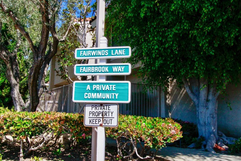 A sunny day in the Fairview Village is very peaceful area with street board and also the street full of trees and plants.