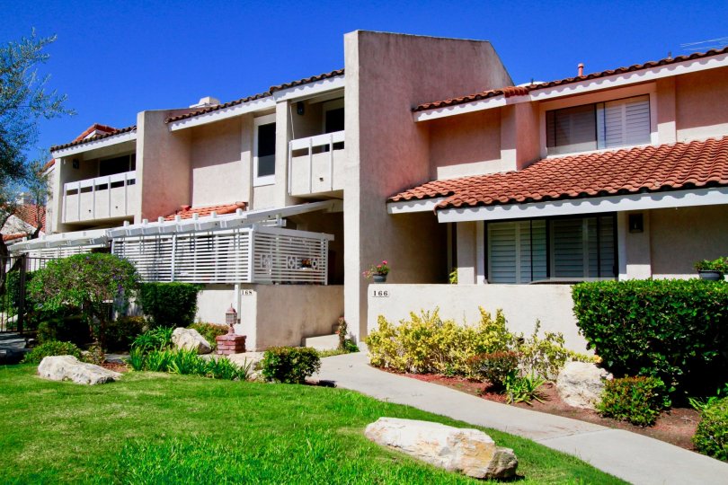 The house in the Fairview Village is very beautyful with trees and plants and also with lawn, fencing.