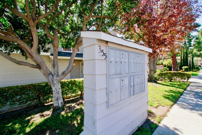 Mailboxes shown in front of the colorful trees of Harbor Pointe South Community residing in Costa Mesa, California