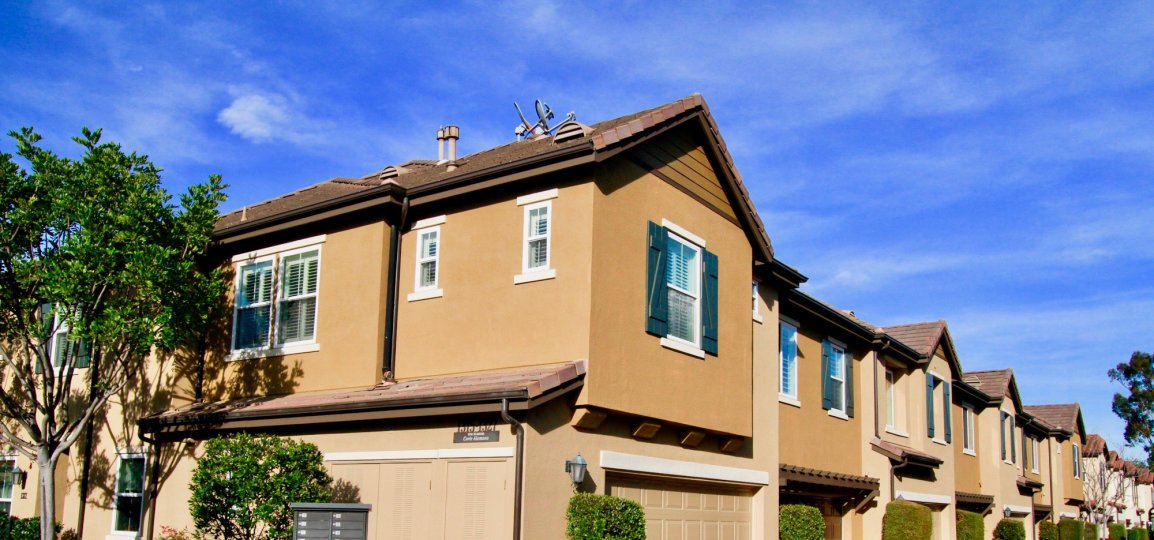 THE APARTMENTS HOUSES ARE LOOKING LIKE SAME AND MORE WINDOWS ALSO AVAILABLE AT THE FRONT SOME TREES ALSO THERE AND THE SKY LOOKING SUNSHINE.