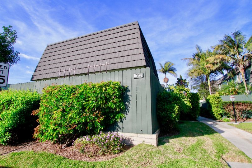 A fenced in building surrounded by shrubs in the Mesa Verde Villas community of Costa Mesa CA