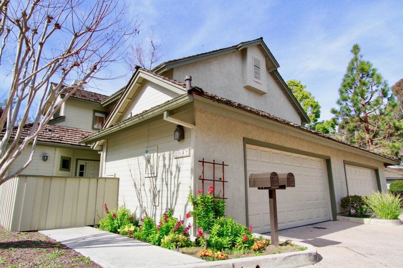 THE MEDIUM SIZE HOUSE LOCATED ALONE AND SOME PLANTS WITH PINK COLOUR FLOWERS ALSO AVAILABLE AND SOME TREES ALSO NEAR TO THE HOUSE.