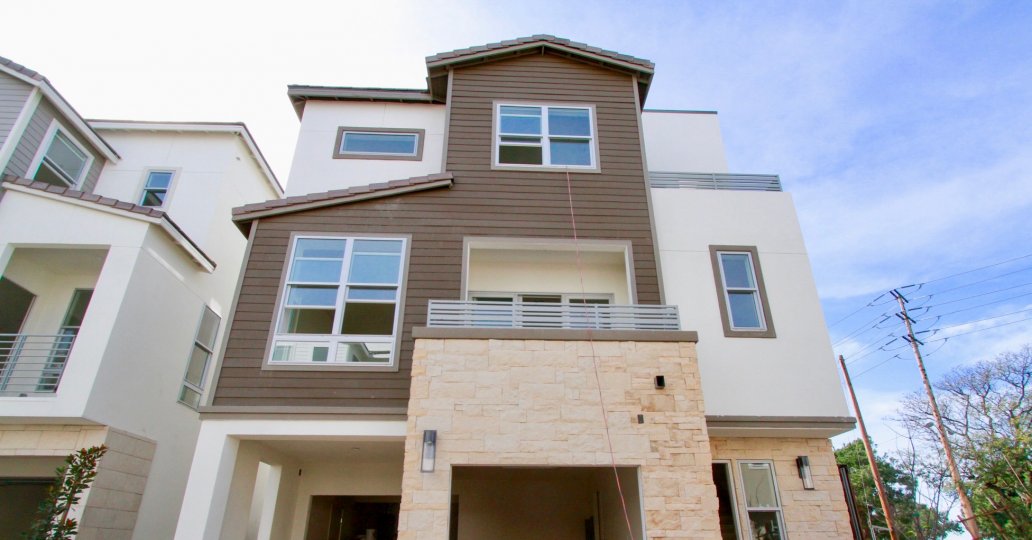 Seabreeze homes with balconies and power lines on a sunny day.