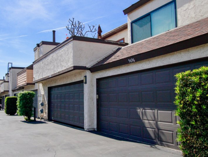 A garage and front view of a unit at Bowers Condominiums on a sunny day