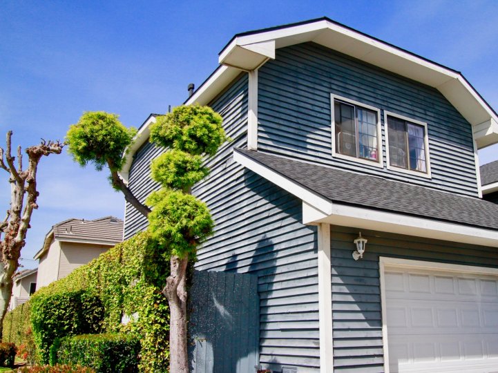 A sunny day at the garage door of a two-floor house in the Crescent Manor neighborhood