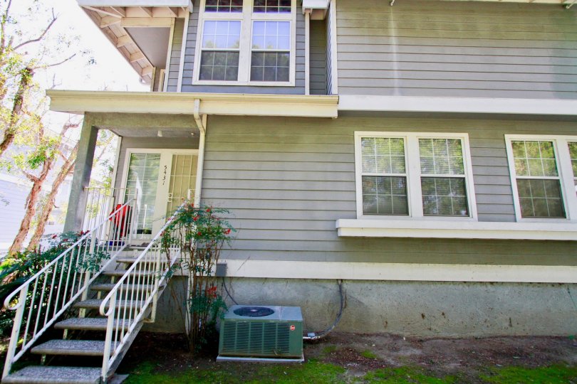 A HOUSE WITH WINDOWS GLASS AND THE STEPS ALSO AVAILABLE FOR MAIN DOOR AND SOME PLANTS ALSO NEAR TO THERE AT THE MORNING