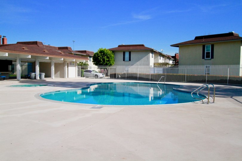 A beautiful house covered with swimming pool in front side