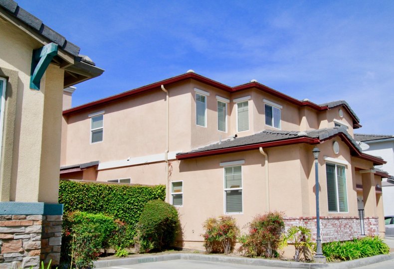 THE BUILDING WITH ROOF TOP AND A SMALL ROOM ALSO NEAR TO THE BUILDING SOME PLANTS AND A POST LIGHT ALSO NEAR TO THE BUILDING