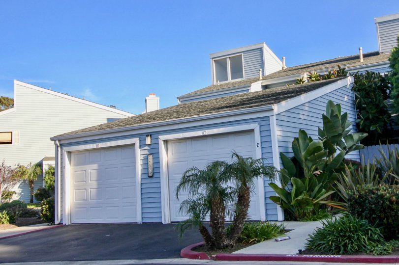 a pleasent day in the dana vista with house that has roofless top and closed parking door on garden