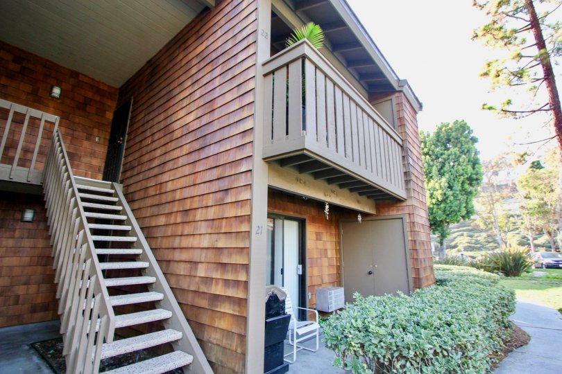 Villa in Harbor Creek has dense bushes in front of the door with chairs and dustbin