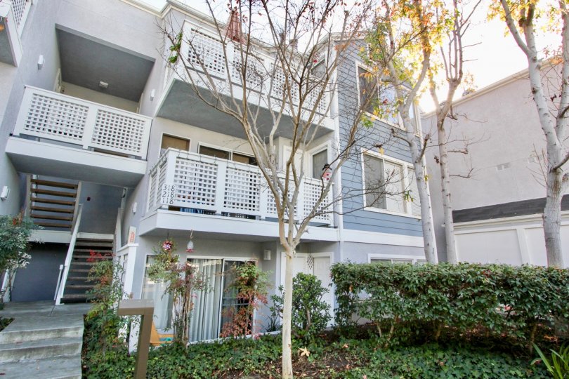 Side view with front small garden and trees of Harbor Walk community, Dana Point, CA