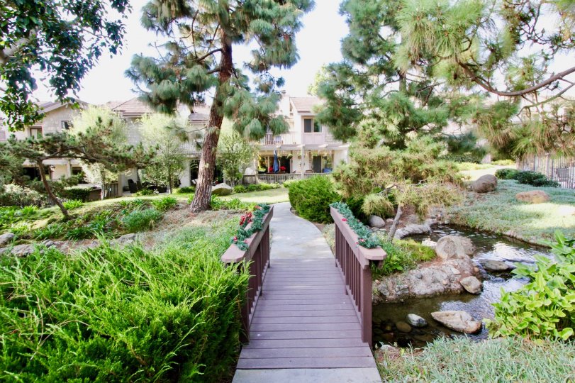 A great day in the Old Mill Pond with a garden in front of a building.
