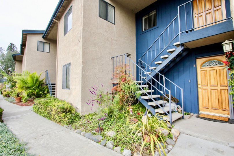 A day in the Sea View Condos with a stair case and wooden door.
