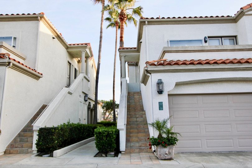 A great day in the Tennis Villas with some palm trees nearby two houses.