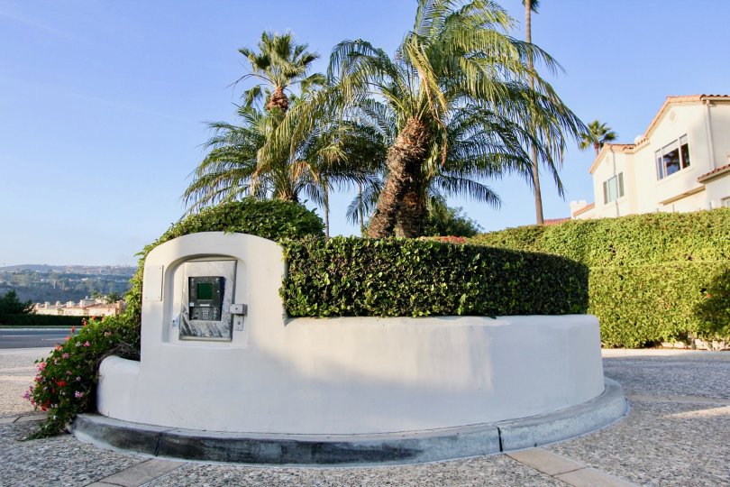 A round cement island with an intercom on it's side at Tennis Villas in Dana Point CA