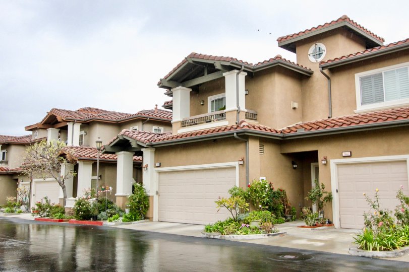 Residential area with porches, garages, and is tan in color located in Liberty Founder of Village community.