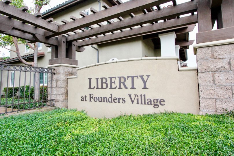 front to wall of Liberty Founder of Village has full of bushes with cutting bushes