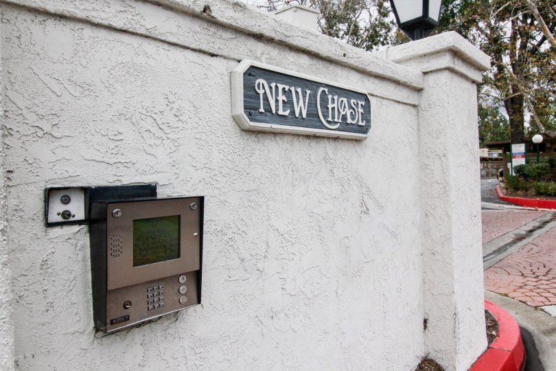 The board New chase is fixed in the wall where telephone booth is also fixed in the same wall