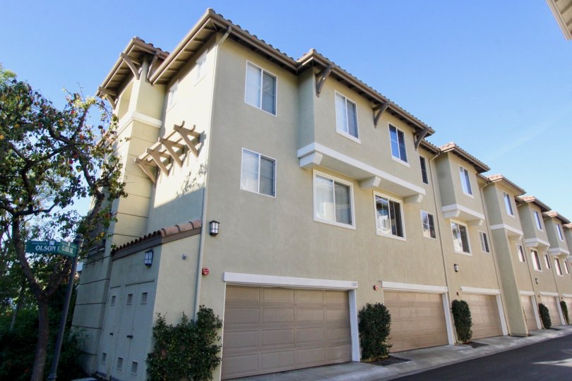 A beautiful apartment in the Amerige Heights with glass windows, big trees and ornamental plants near the road side.