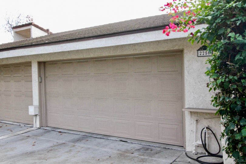 Car shed of villa is closed in Casa Del Vista with tap and flowers in plants