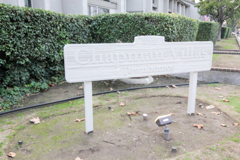 A day in the Chapman Villas with a sign board and plant.