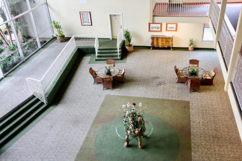 Inside a lobby in the Club Acacia community with chairs and tables