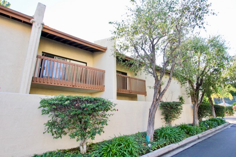 A apartment building in Country Villas with a balcony and trees.