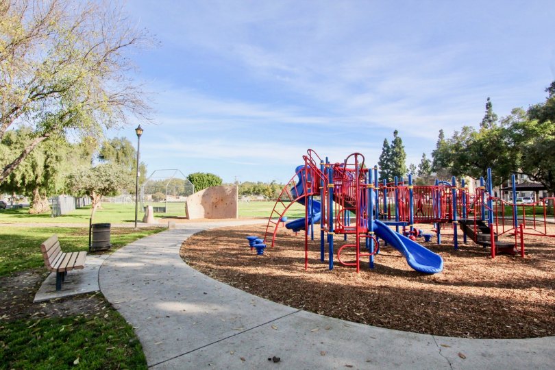 A clear day in the Fullerton Fountains with children's playground and picnic tables.