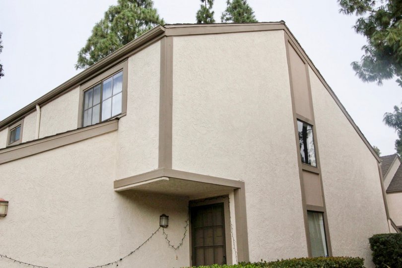 Unique shaped residential area with a black door with trees surround area located in the Hidden Lakes community.