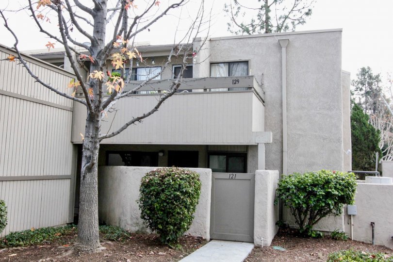An apartment building of Park Ridge with a balcony and a gate on a cloudy day.
