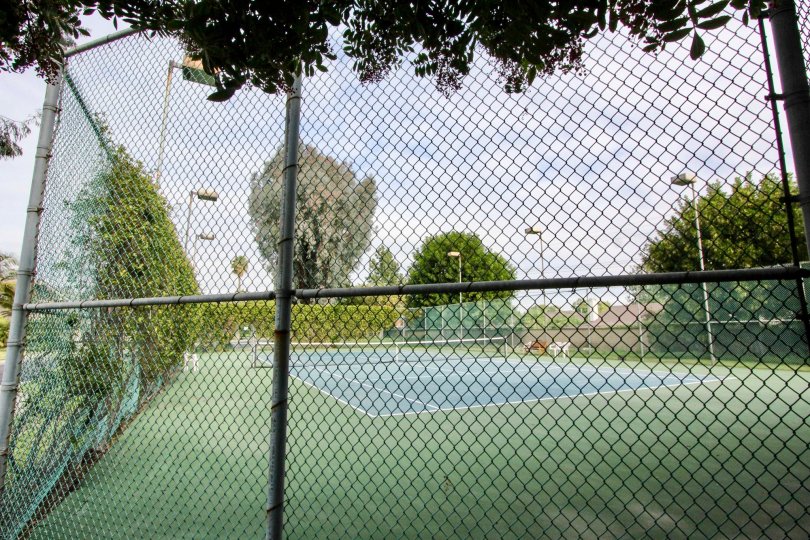 Fenced in tennis courts and light post Stone Pine Estates Fullerton CA
