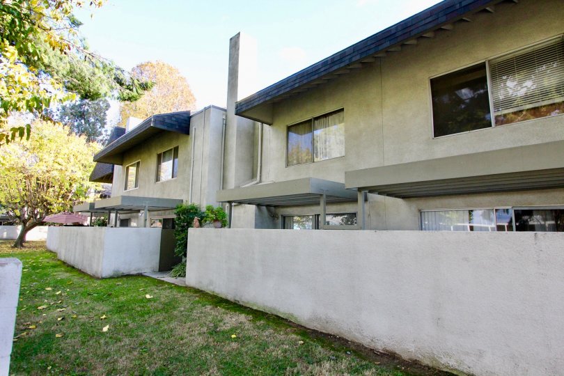A two-story apartment complex with exterior walled-fences at Bixby Green, in Garden Grove, California.