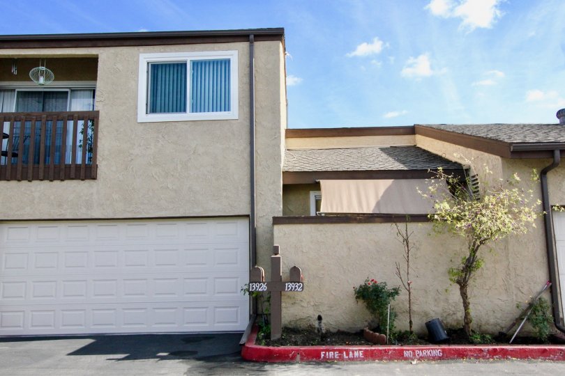 Back side view of the building having trees and plants near to the building in Garden Terrace Townhomes