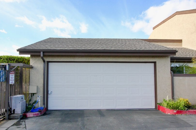 clean and clear area view in front garage near house having trees and plants around in Garden Terrace Townhomes