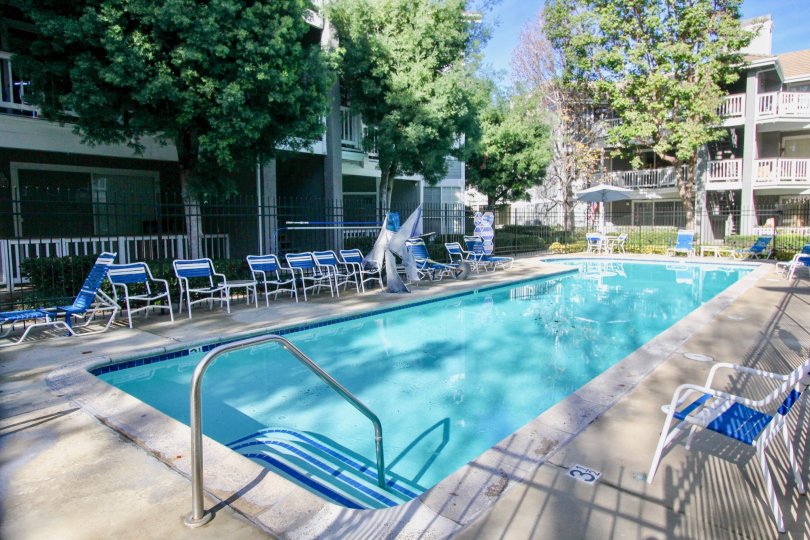 Pool area with empty chairs inside the Greenbrier terraces community