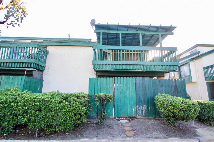 The Greenhouse West in the Garden Grove with a house and bushes