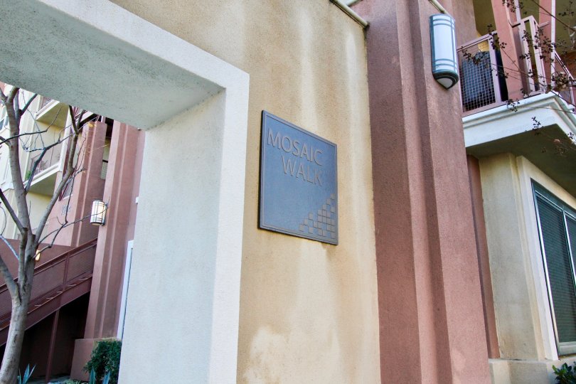 A pleasant day in the community of Lotus Walk featuring a Mosaic Walk plaque near the residences