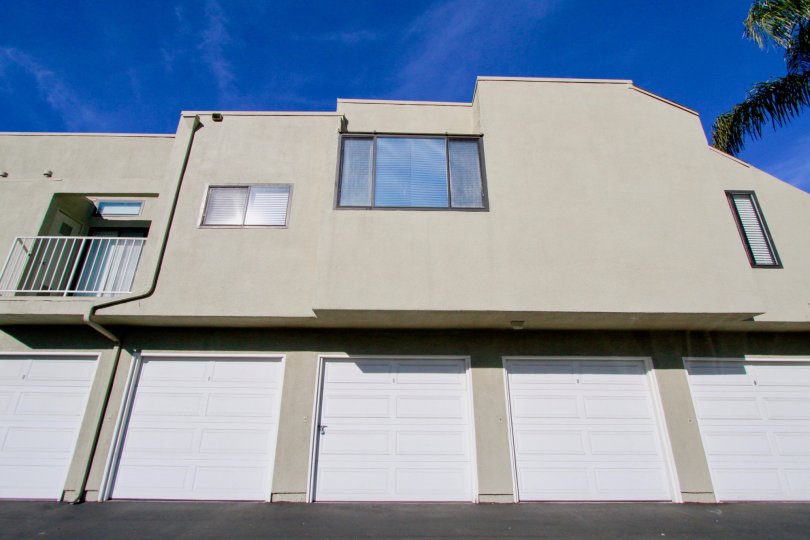 an apartment buliding of Bookstone with 5 garage doors and three windows