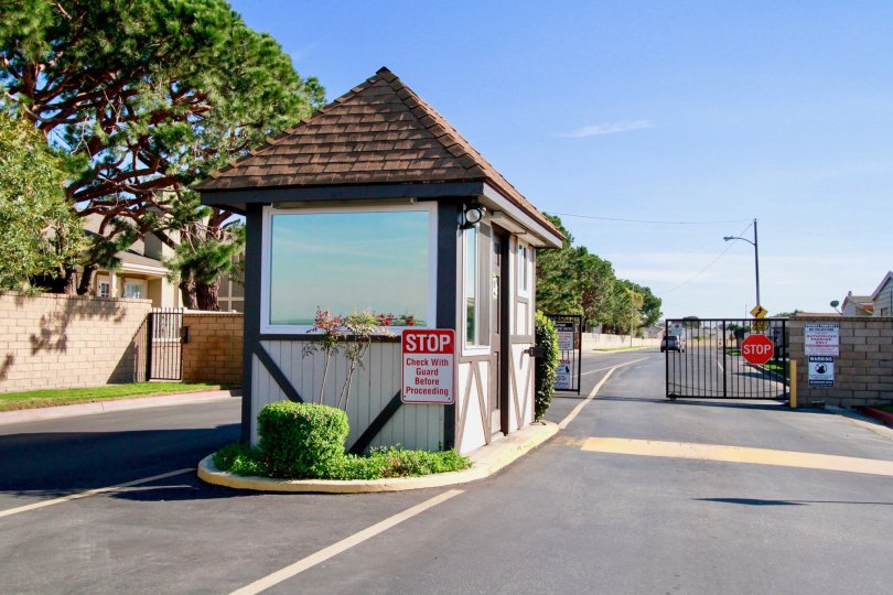 Gables Huntington Beach California bulding to road very long distance sequrity attached and gate near to lamp post sequrity room window attached back side tree