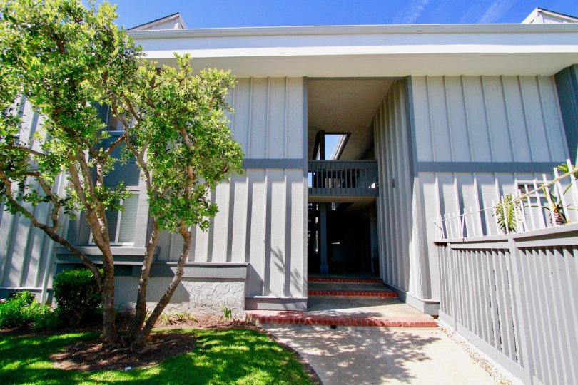 Harboring Villas apartments with a staircase and fences on a sunny day.