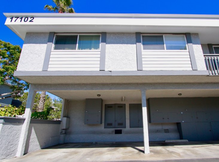 White residential building with number on top located in Harbour Pacific community.